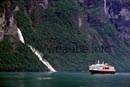 Meanwhile, swung in in the Geiranger fjord, the HUrtigrute passes the waterfall Friaren. Shortly after, the fast steamboat gets ahead of the car ferry by greeting with the hooter.
