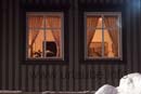 Warmness and comfortable feeling shine out of the windows of the old houses in the snowy streets and alleys of Tromsö