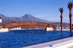 View to the bridge at the sea pool with the mountains of Adeje in the background