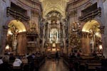 The interior of the St. Peter's Church is arranged in a laborious baroque style and reminds on the galleries of a theatre