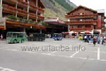 Station sqare of Zermatt; attention is to be paid to the little electric cars